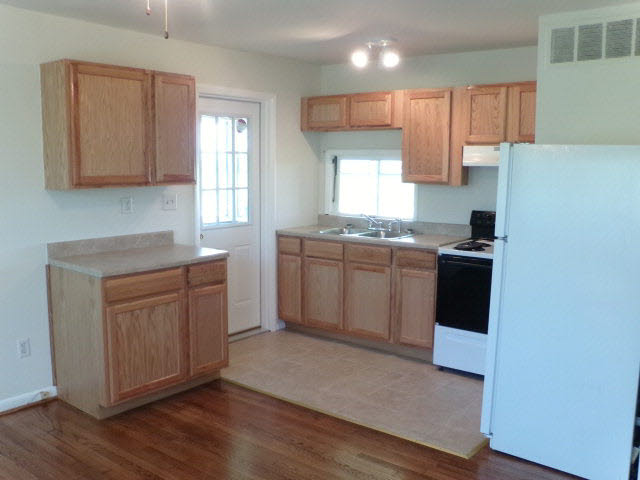 1659 Orchard Road Mount Jackson, VA 22842 - Photo 7 of 13 a kitchen with granite countertop white cabinets and white appliances