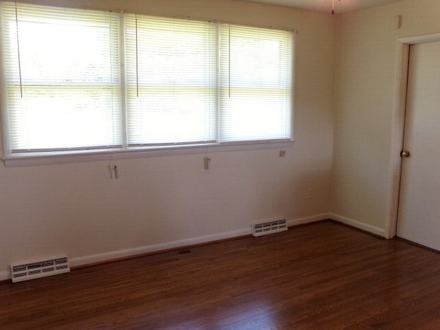 1659 Orchard Road Mount Jackson, VA 22842 - Photo 9 of 13 an empty room with wooden floor and windows