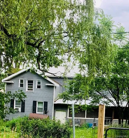 a front view of house with yard and green space