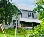 3 Burr Road Cochecton, NY 12726 - Photo 2 of 13 a view of a house with brick walls and a yard with plants