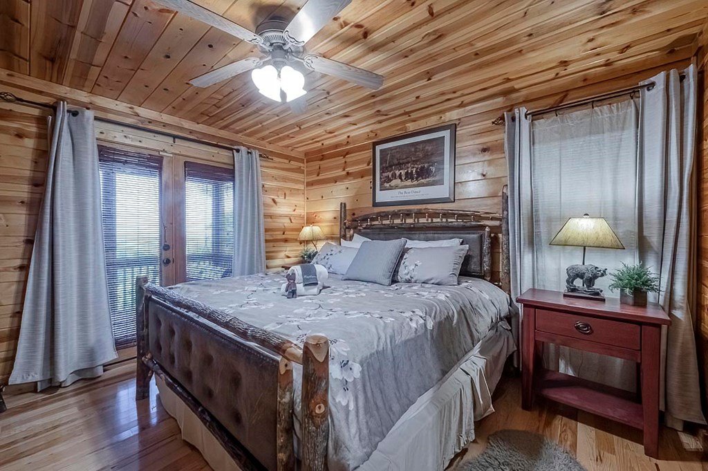 1722 Sun Rock Mountain Road Blue Ridge, GA 30513 - Photo 13 of 67 a bedroom with a bed a chandelier and dresser