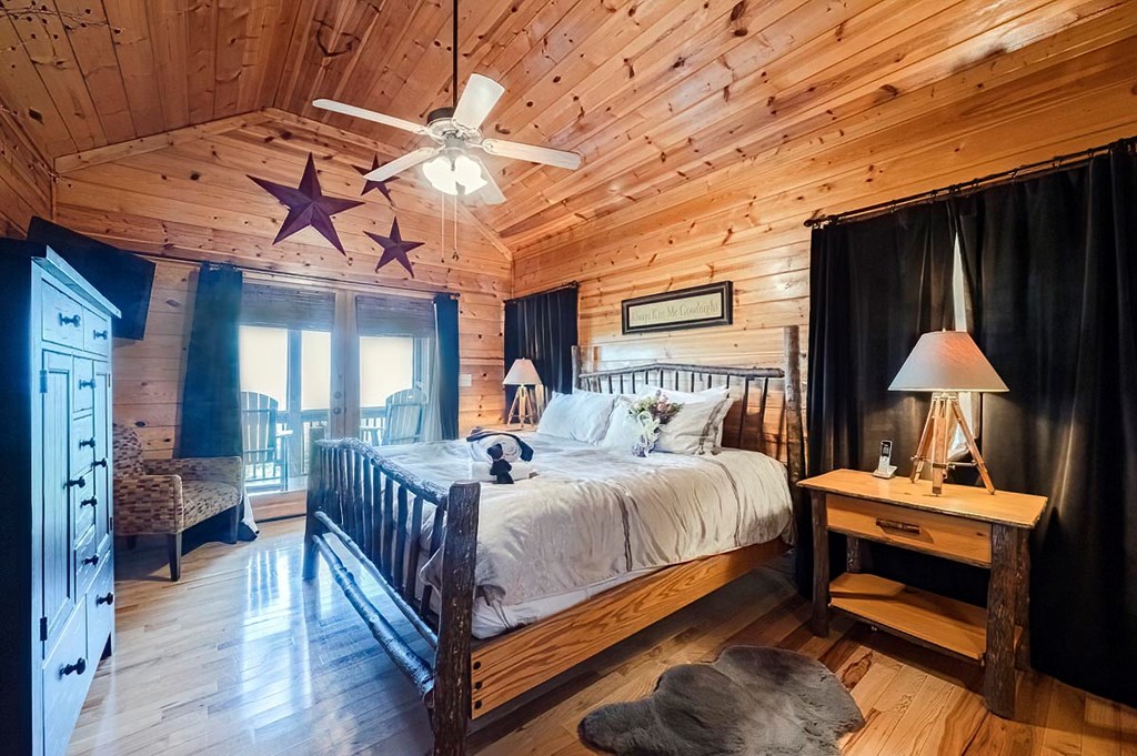 1722 Sun Rock Mountain Road Blue Ridge, GA 30513 - Photo 22 of 67 a bedroom with a bed and wooden floor