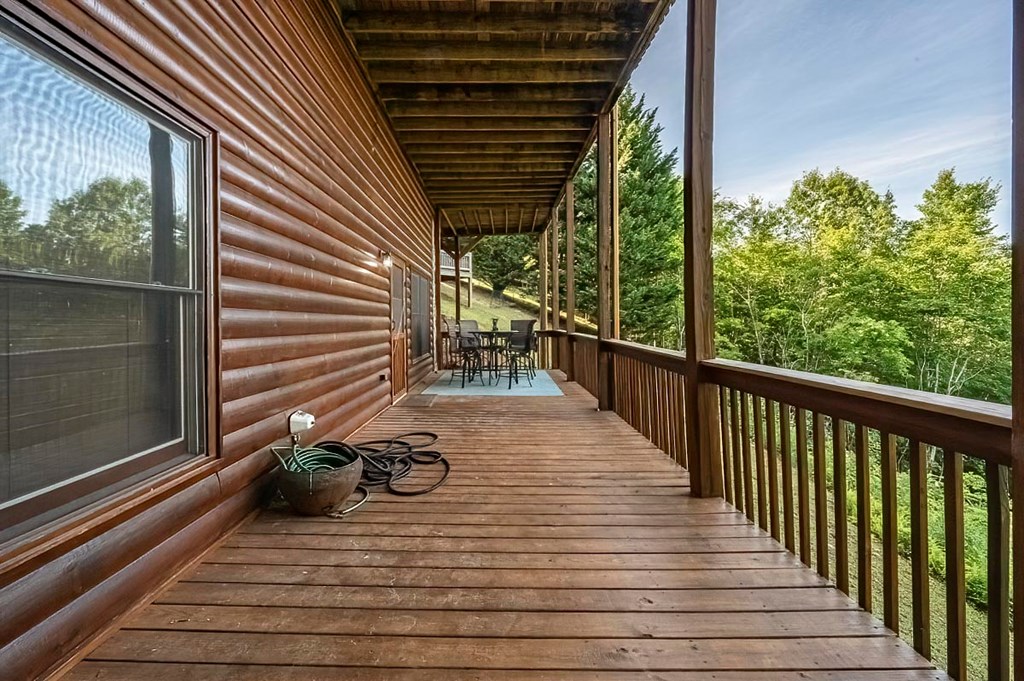 1722 Sun Rock Mountain Road Blue Ridge, GA 30513 - Photo 43 of 67 a view of a balcony with chair and wooden floor