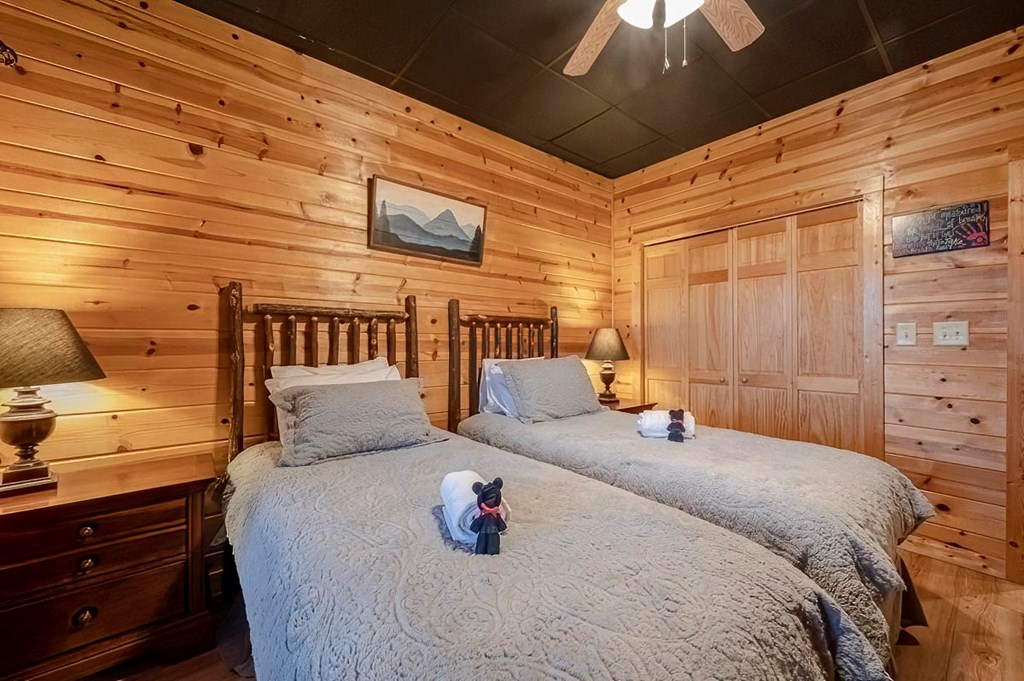 1722 Sun Rock Mountain Road Blue Ridge, GA 30513 - Photo 58 of 67 a bedroom with a bed a dresser and a night stand