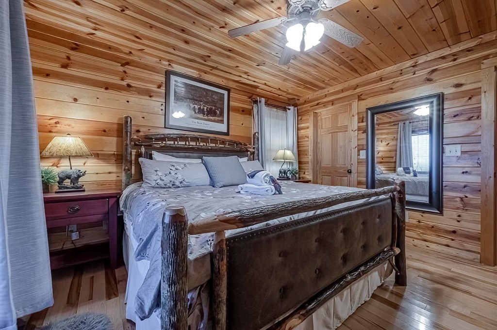 1722 Sun Rock Mountain Road Blue Ridge, GA 30513 - Photo 66 of 67 a bed sitting in a spacious bedroom next to a window