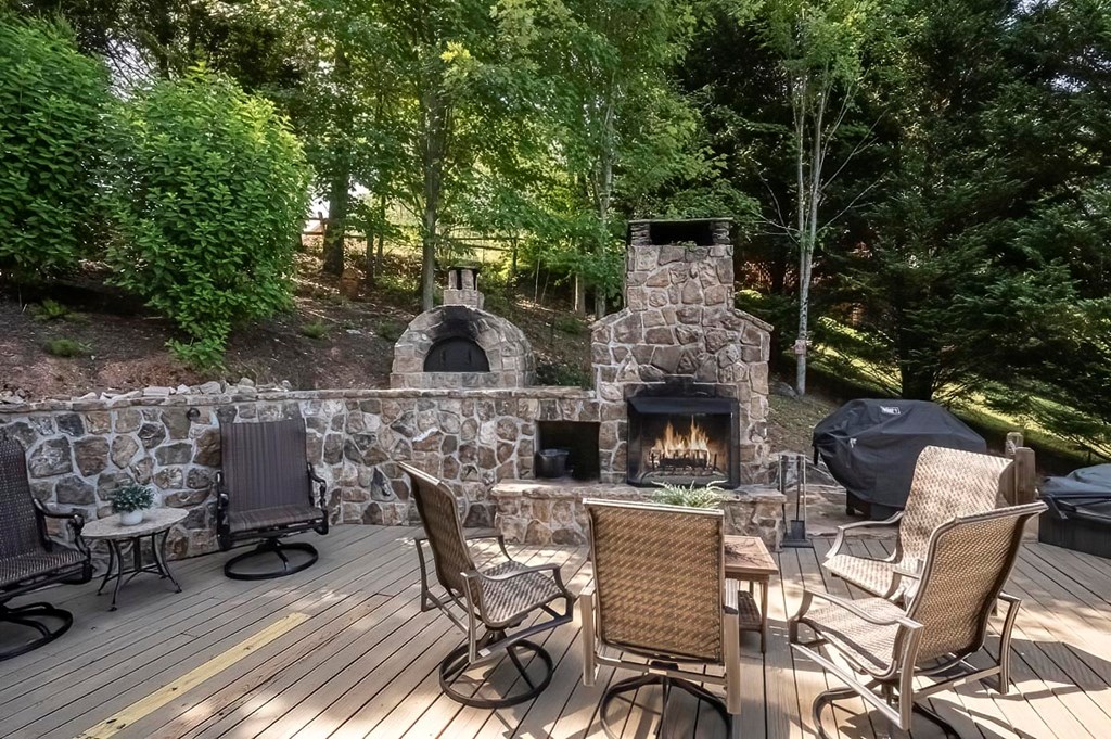 1722 Sun Rock Mountain Road Blue Ridge, GA 30513 - Photo 7 of 67 a view of a patio with table and chairs and potted plants