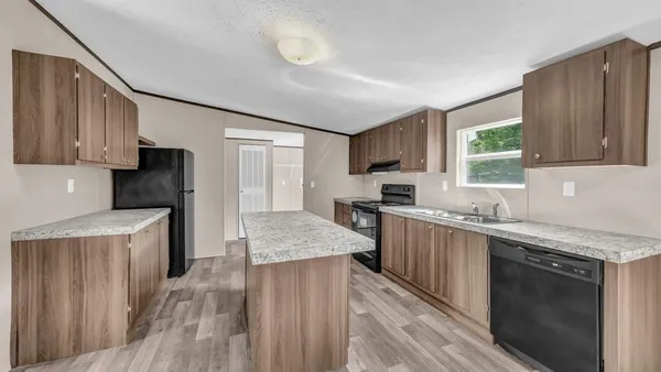 a kitchen with a sink stove top oven and wooden cabinets