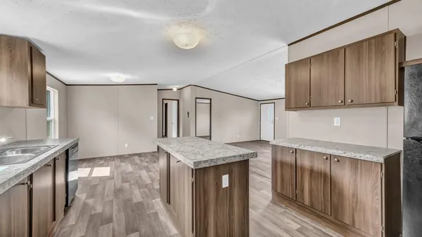 a kitchen with granite countertop cabinets stainless steel appliances and a counter space