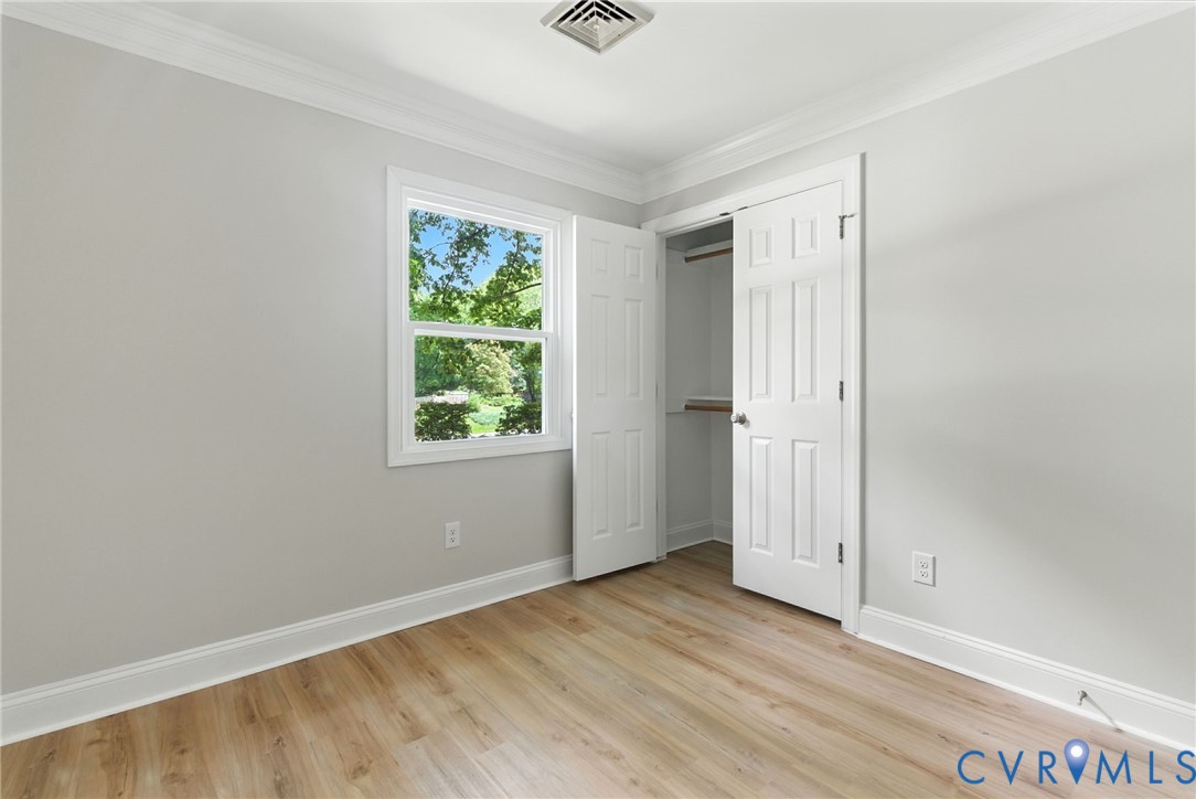 5430 Solaris Drive Chesterfield, VA 23832 - Photo 8 of 15 an empty room with wooden floor and windows