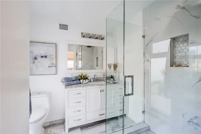 a spacious bathroom with a granite countertop sink mirror and toilet