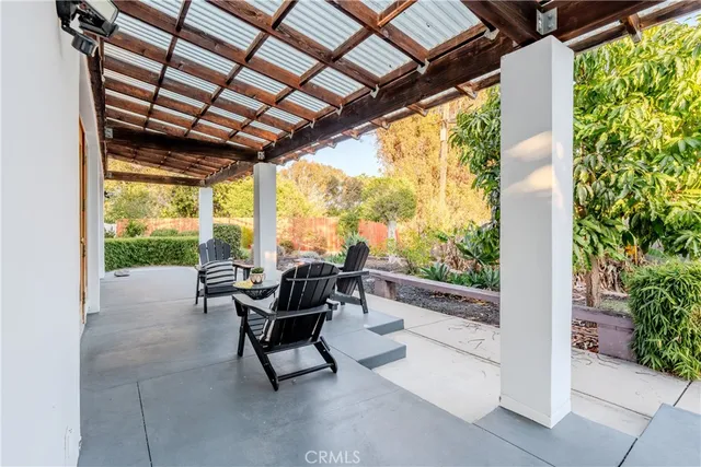 a building outdoor space with patio furniture and garden