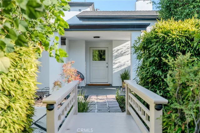 a balcony with potted plants and wooden fence