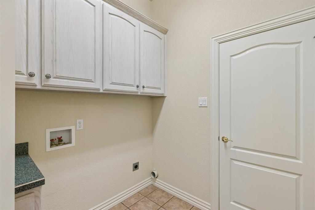 1727 Ridgecrest Drive Cleburne, TX 76033 - Photo 28 of 32 Built-in cabinetry with decorative hardware, tiled flooring, and a countertop surface