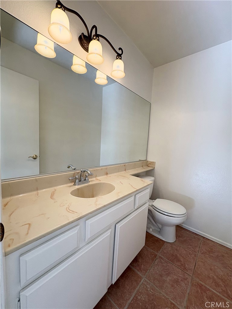 18223 Soledad Canyon Road, Unit 29 Canyon Country, CA 91387 - Photo 8 of 23 a bathroom with a granite countertop sink mirror and toilet