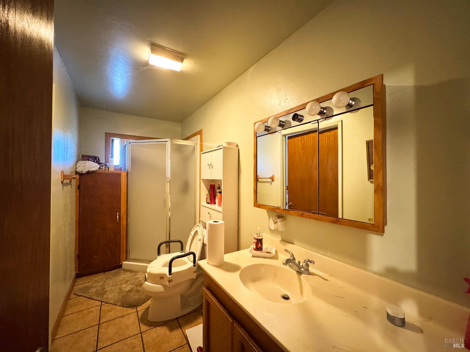 4400 Lake Ridge Road Ukiah, CA 95482 - Photo 14 of 78 a bathroom with a granite countertop sink and a mirror