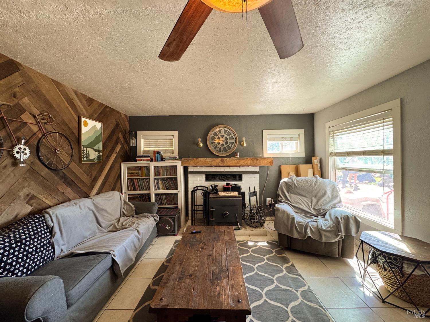 4400 Lake Ridge Road Ukiah, CA 95482 - Photo 62 of 78 a living room with furniture a ceiling fan and a window