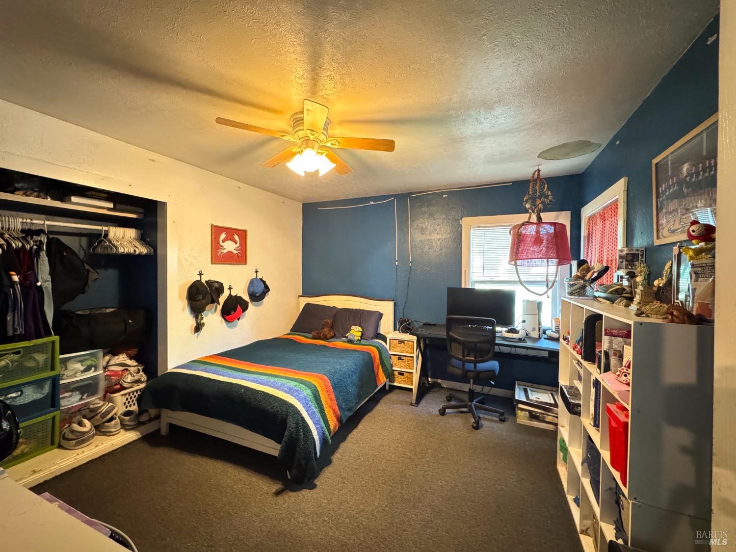 4400 Lake Ridge Road Ukiah, CA 95482 - Photo 66 of 78 a bedroom with a bed gym equipment and a large window