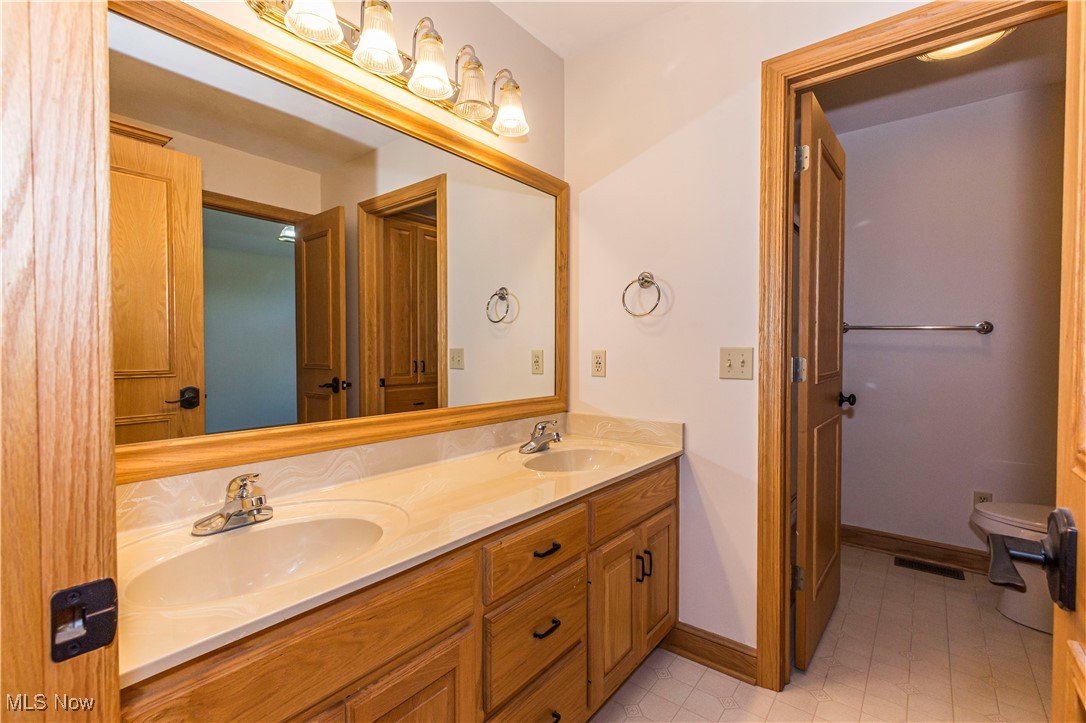 1570 Reimer Road Wadsworth, OH 44281 - Photo 27 of 48 Jack and Jill bathroom with double vanity and baseboards
