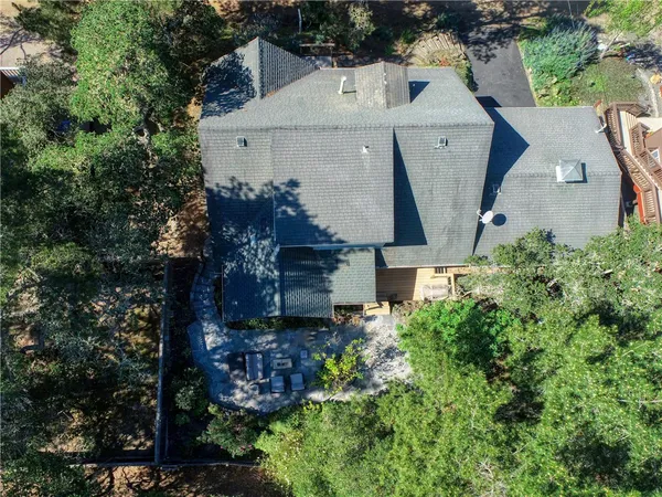 an aerial view of a house with a yard
