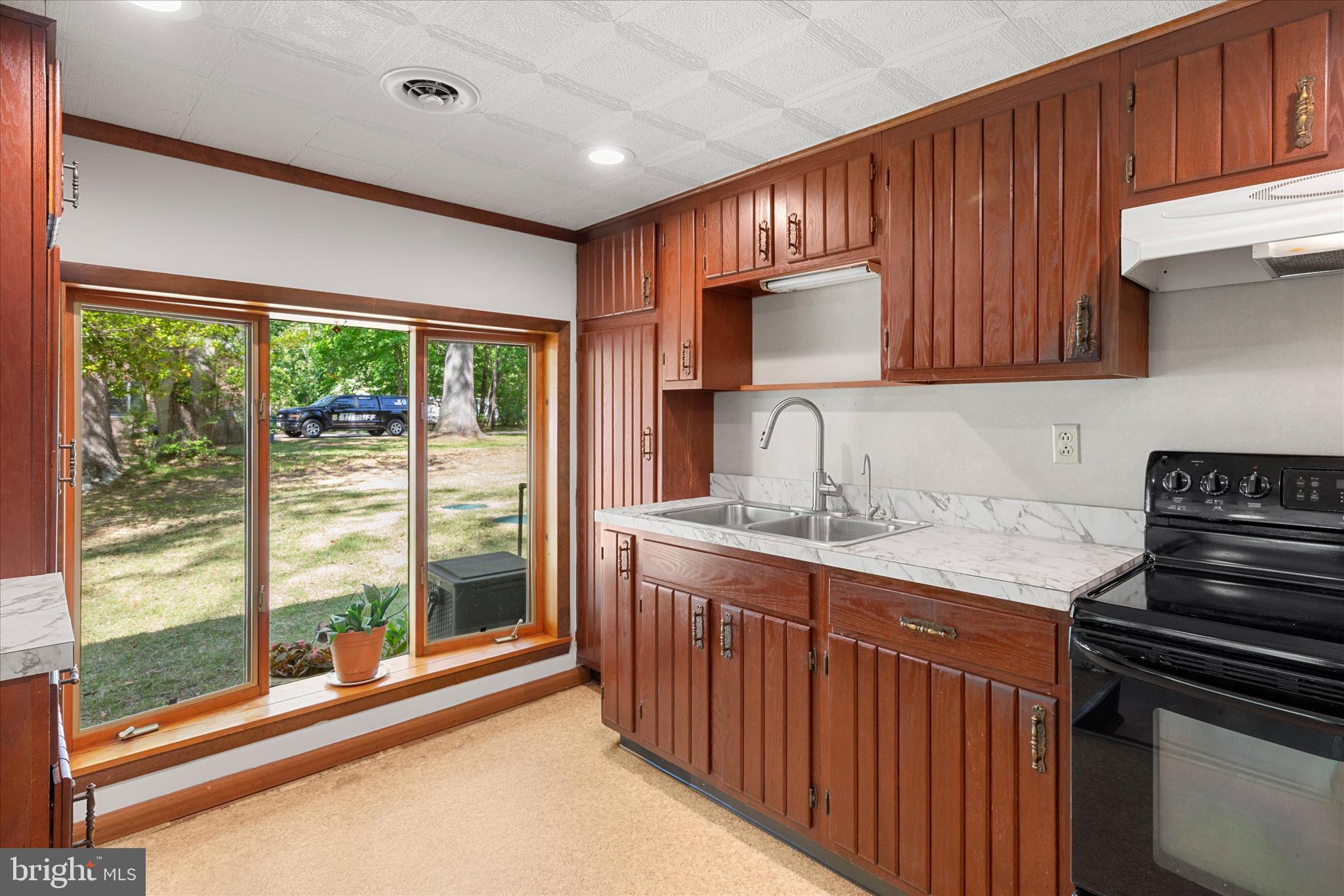 251 Rings End Road Millington, MD 21651 - Photo 6 of 47 a kitchen with stainless steel appliances granite countertop a stove a sink and a microwave