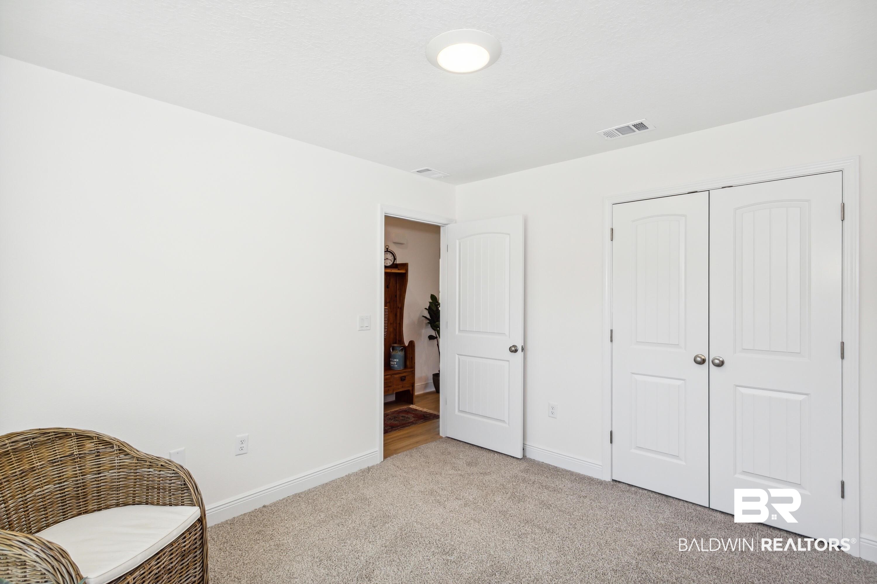 150 St Stephens Court Atmore, AL 36502 - Photo 14 of 21 Living area with light carpet