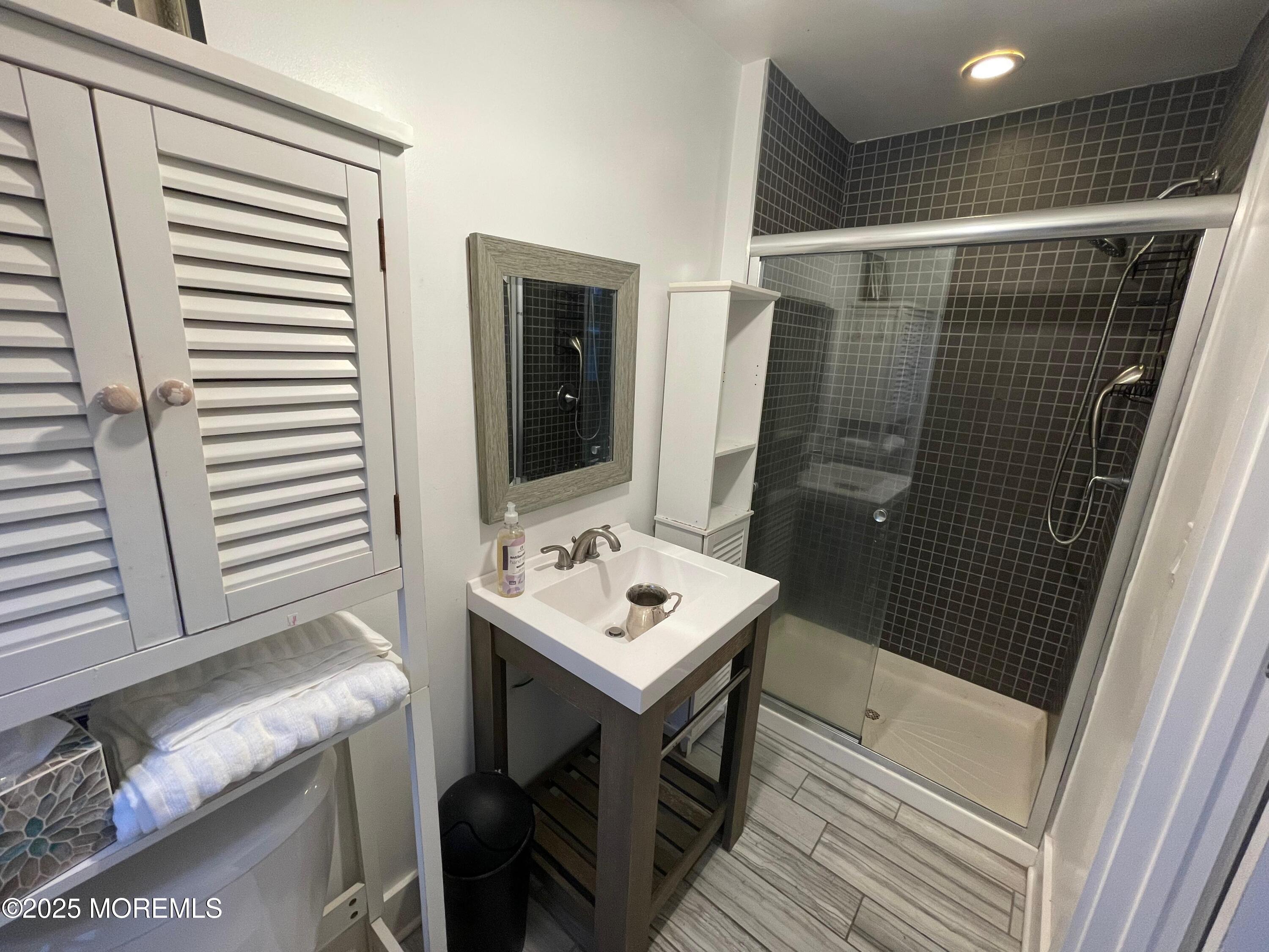90 Poplar Avenue Deal, NJ 07723 - Photo 1 of 4 a bathroom with a sink and a mirror