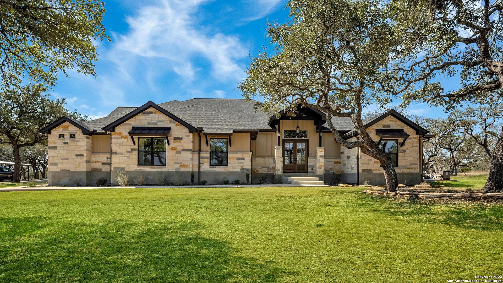 a front view of house with yard and green space