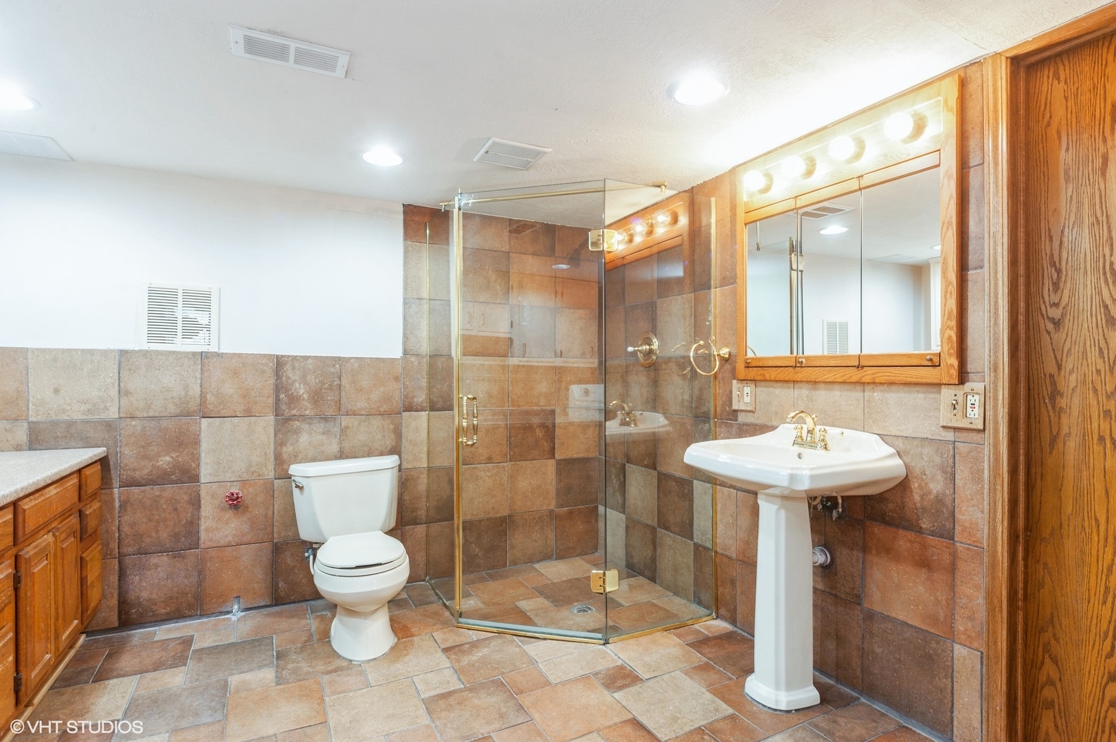 1215 Kenton Road Deerfield, IL 60015 - Photo 13 of 17 a bathroom with a sink toilet and shower