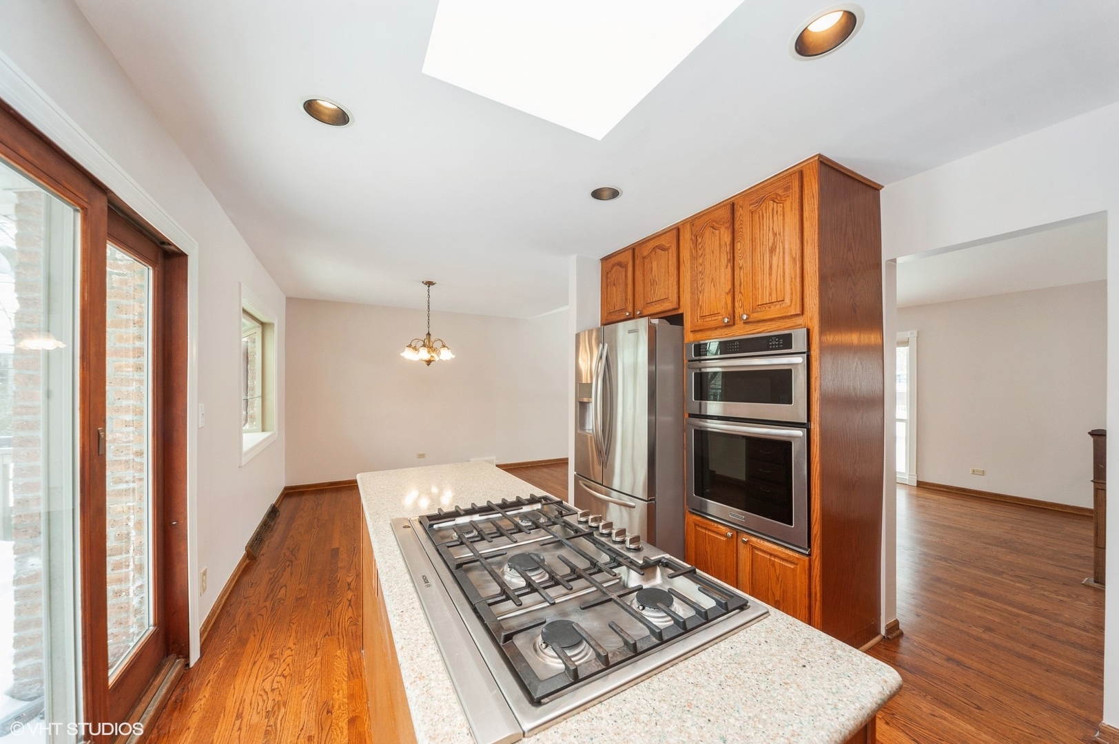 1215 Kenton Road Deerfield, IL 60015 - Photo 3 of 17 a kitchen with stainless steel appliances granite countertop a refrigerator and a stove top oven