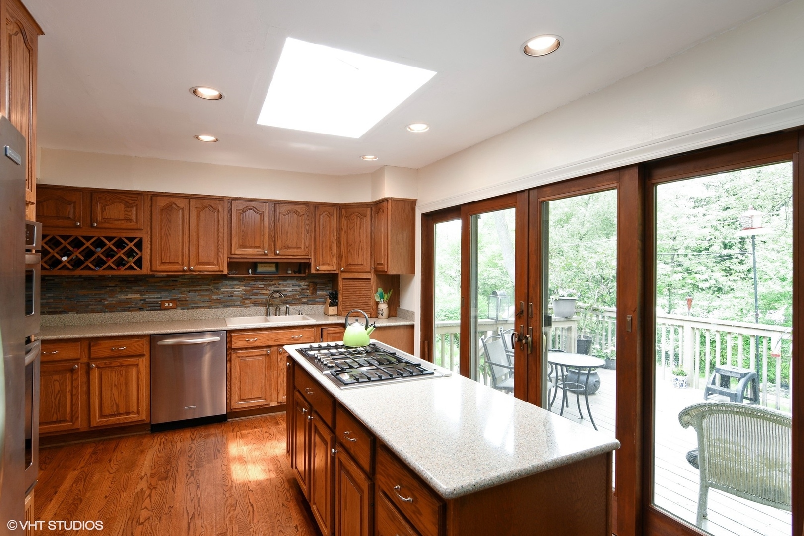 1215 Kenton Road Deerfield, IL 60015 - Photo 4 of 17 a large kitchen with stainless steel appliances granite countertop a stove and a sink