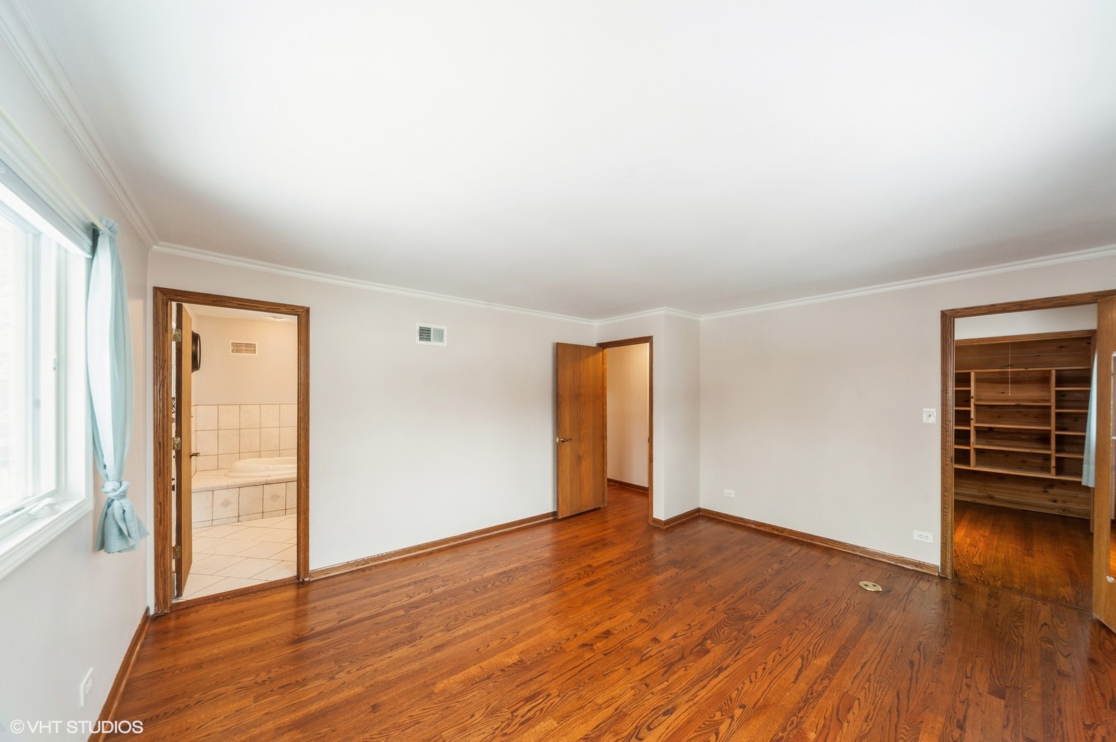 1215 Kenton Road Deerfield, IL 60015 - Photo 6 of 17 an empty room with wooden floor and windows
