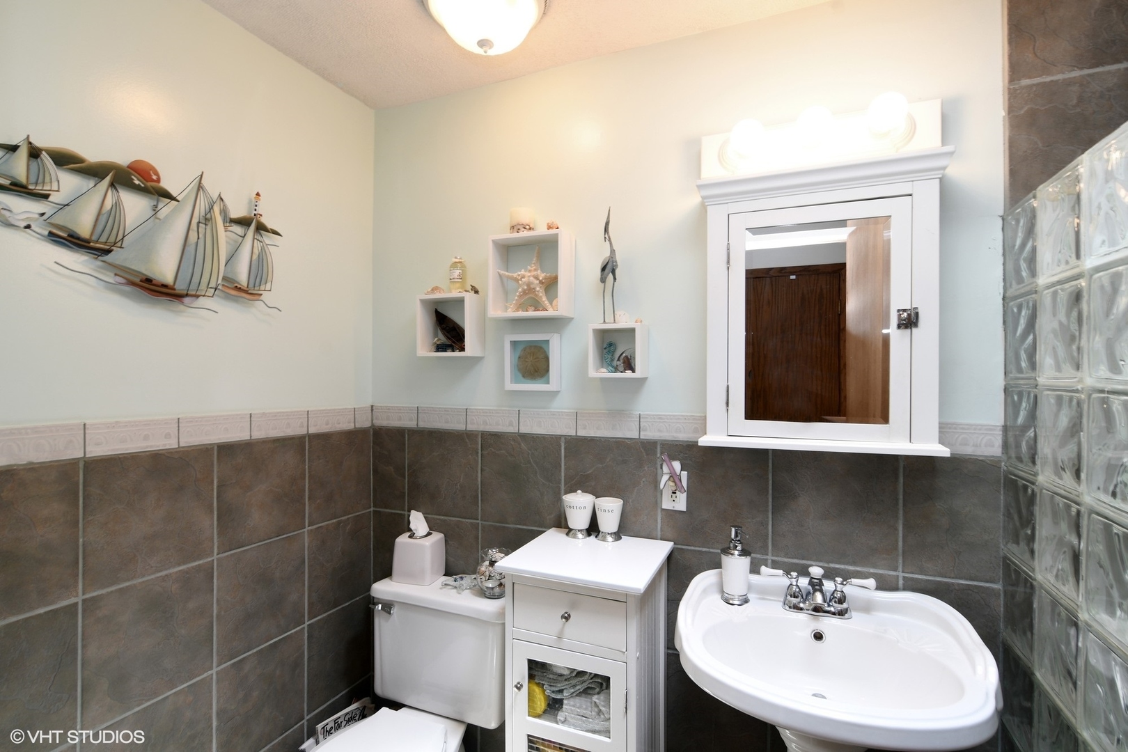 1215 Kenton Road Deerfield, IL 60015 - Photo 9 of 17 a bathroom with a sink a toilet and mirror