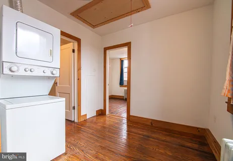 a view of washer and dryer with wooden floor