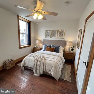 a bedroom with a large bed and a window