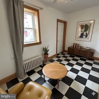 a living room with furniture and a rug