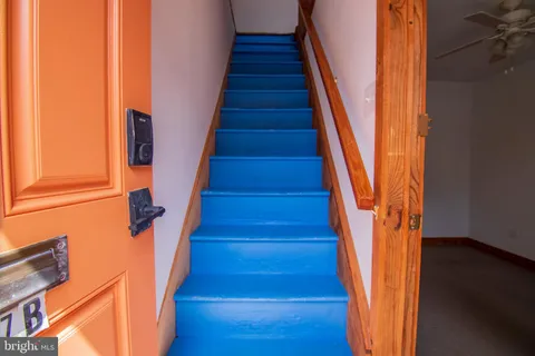 a view of entryway with wooden floor and stairs
