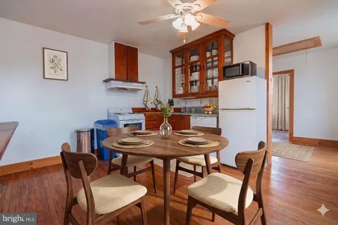 a dining room with furniture and wooden floor