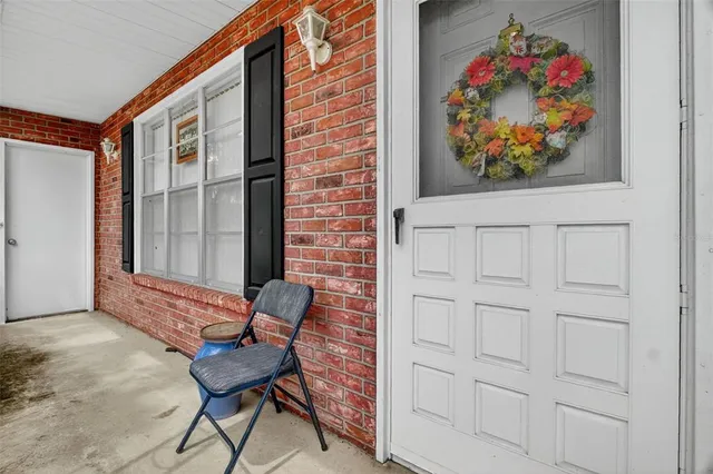 a view of a entryway door back of the house with wooden floor