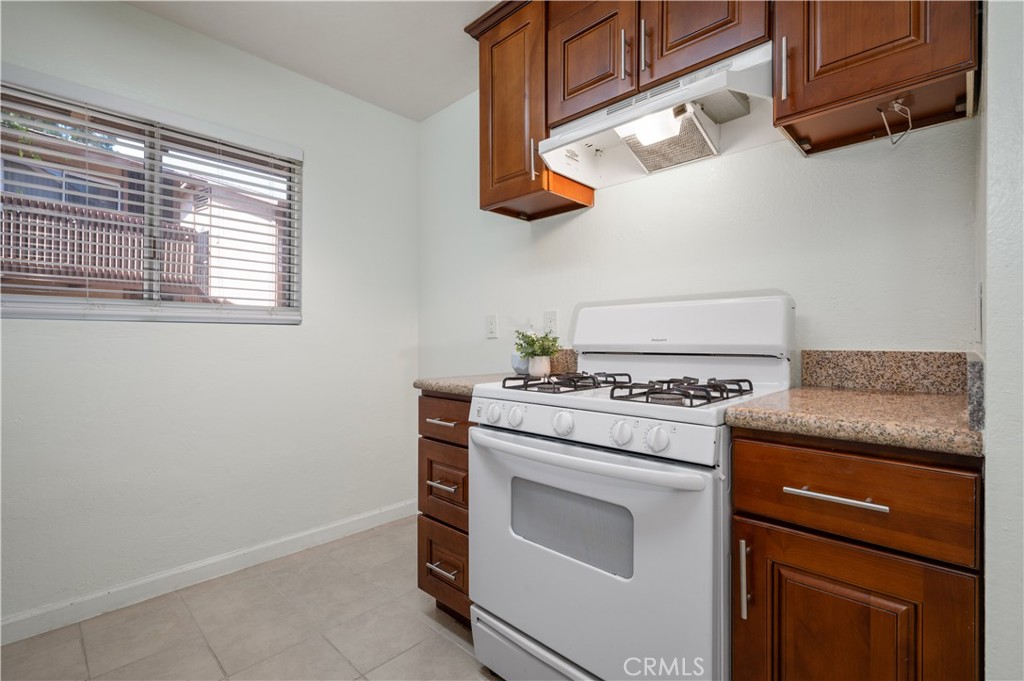 1044 Cabrillo Park Drive, Unit B Santa Ana, CA 92701 - Photo 13 of 49 a kitchen with a stove and a microwave