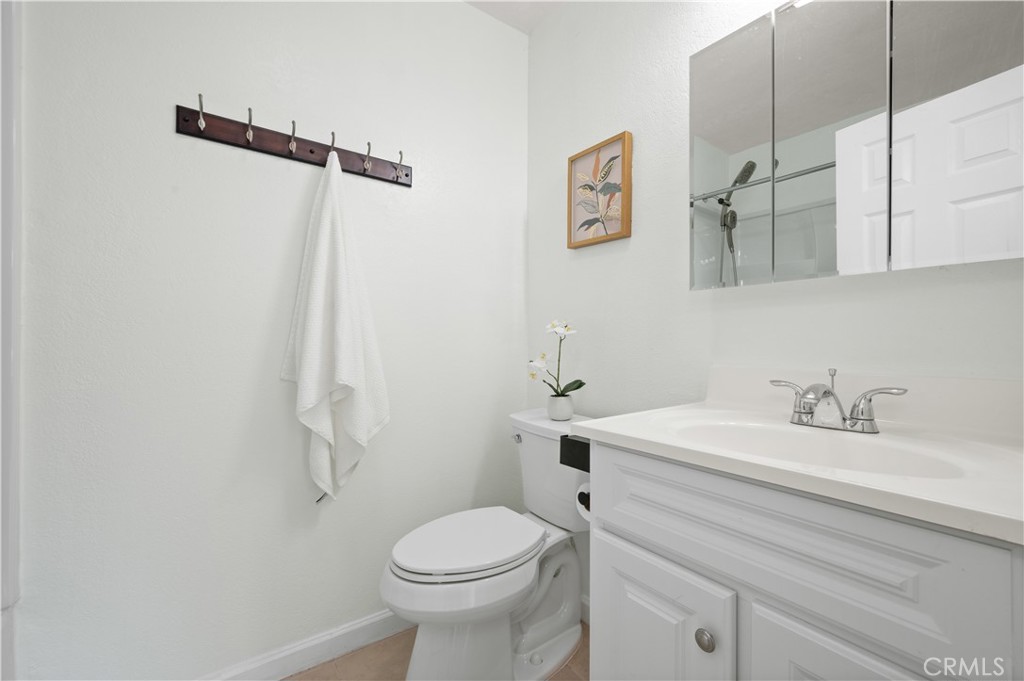 1044 Cabrillo Park Drive, Unit B Santa Ana, CA 92701 - Photo 18 of 49 a bathroom with a sink a toilet and vanity