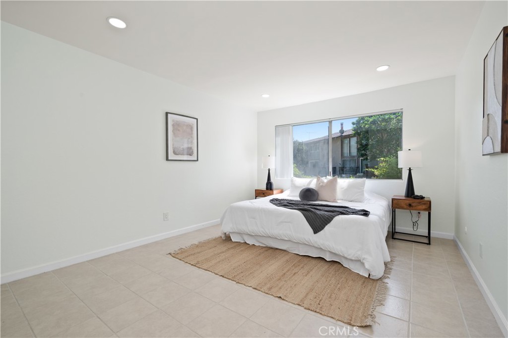 1044 Cabrillo Park Drive, Unit B Santa Ana, CA 92701 - Photo 20 of 49 a bedroom with a bed a window and couch