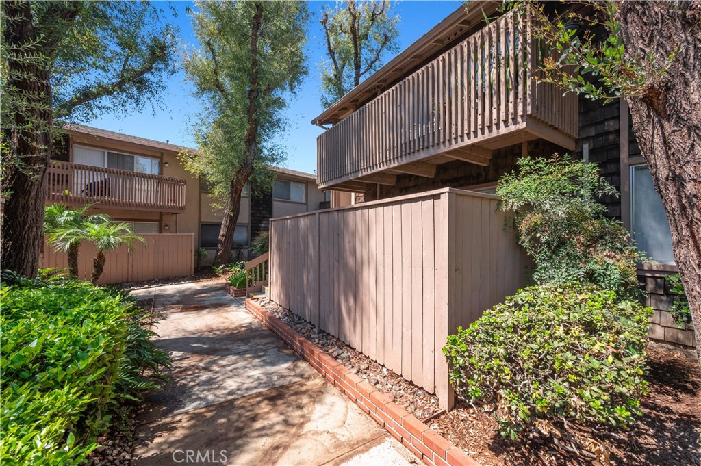 1044 Cabrillo Park Drive, Unit B Santa Ana, CA 92701 - Photo 29 of 49 a view of a pathway of a house with wooden fence and potted plants