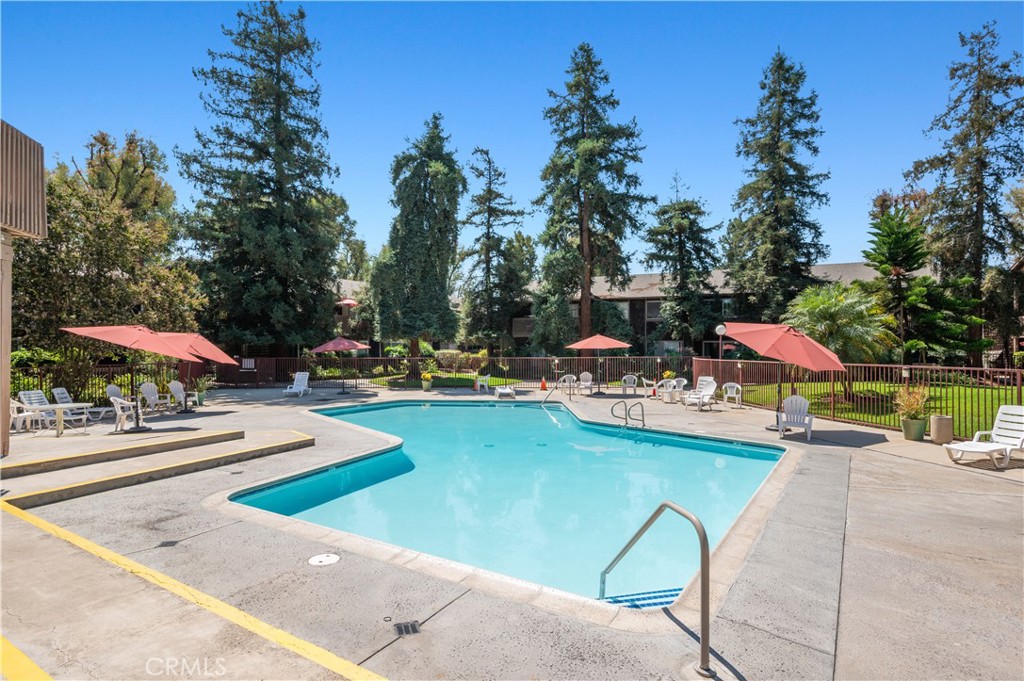 1044 Cabrillo Park Drive, Unit B Santa Ana, CA 92701 - Photo 35 of 49 a view of swimming pool with outdoor seating and trees in the background