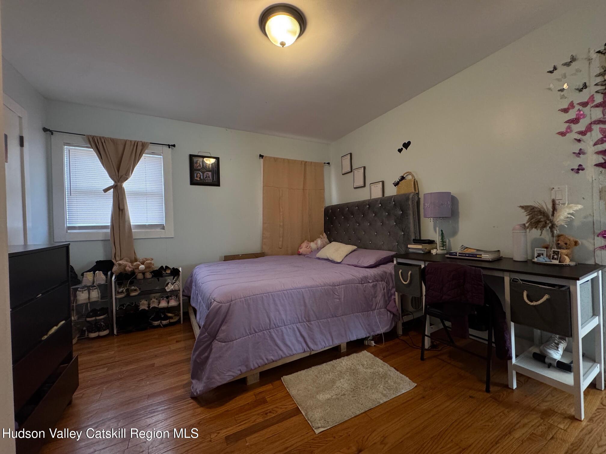 2 Spaulding Lane Saugerties, NY 12477 - Photo 11 of 24 a bedroom with a bed and wooden floor