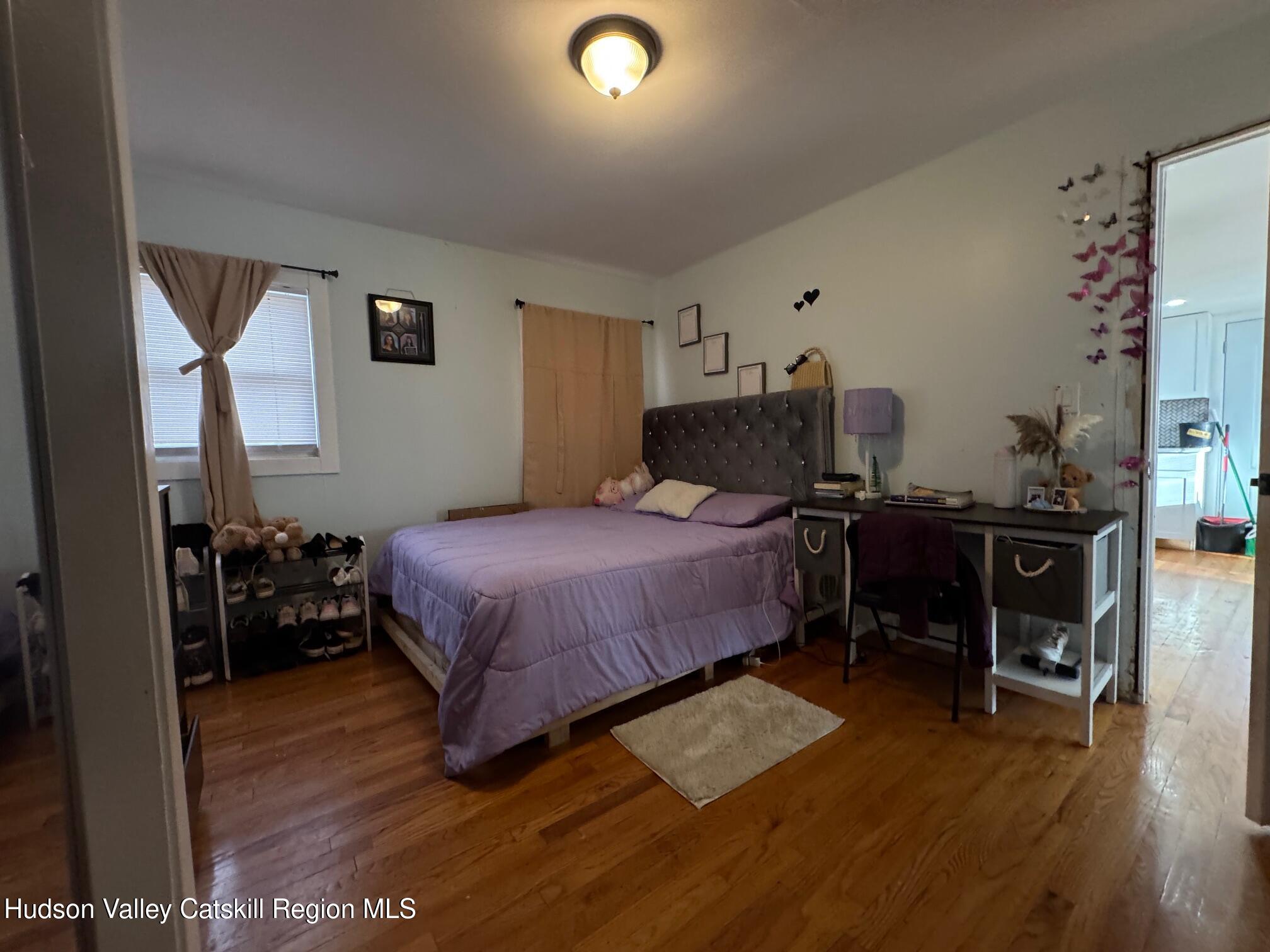 2 Spaulding Lane Saugerties, NY 12477 - Photo 12 of 24 a bedroom with a bed and wooden floor