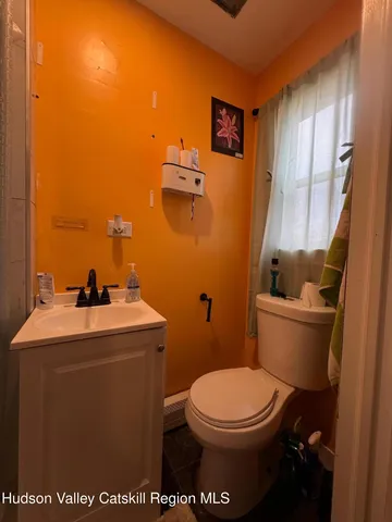 a bathroom with a toilet a sink and mirror