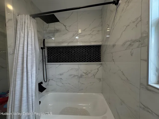 a bathroom with a shower and a bathtub