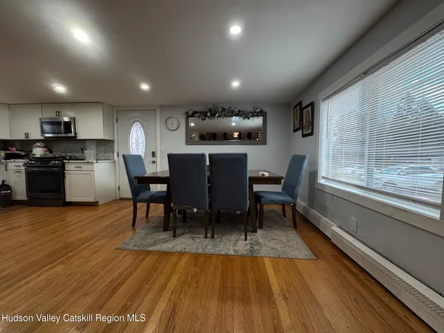 a view of a dining room with furniture window and wooden floor