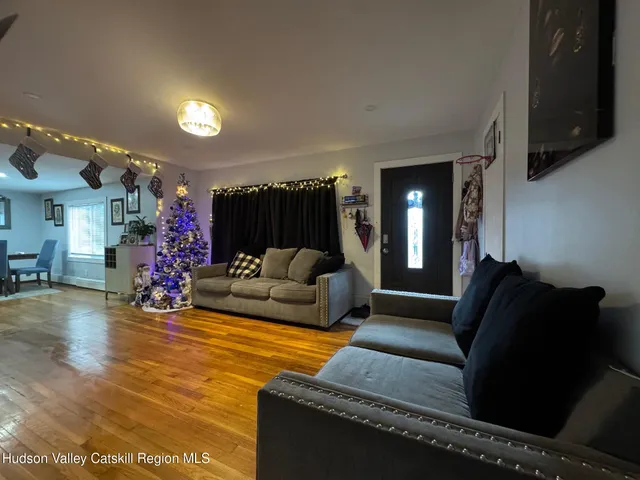 a living room with furniture and a chandelier