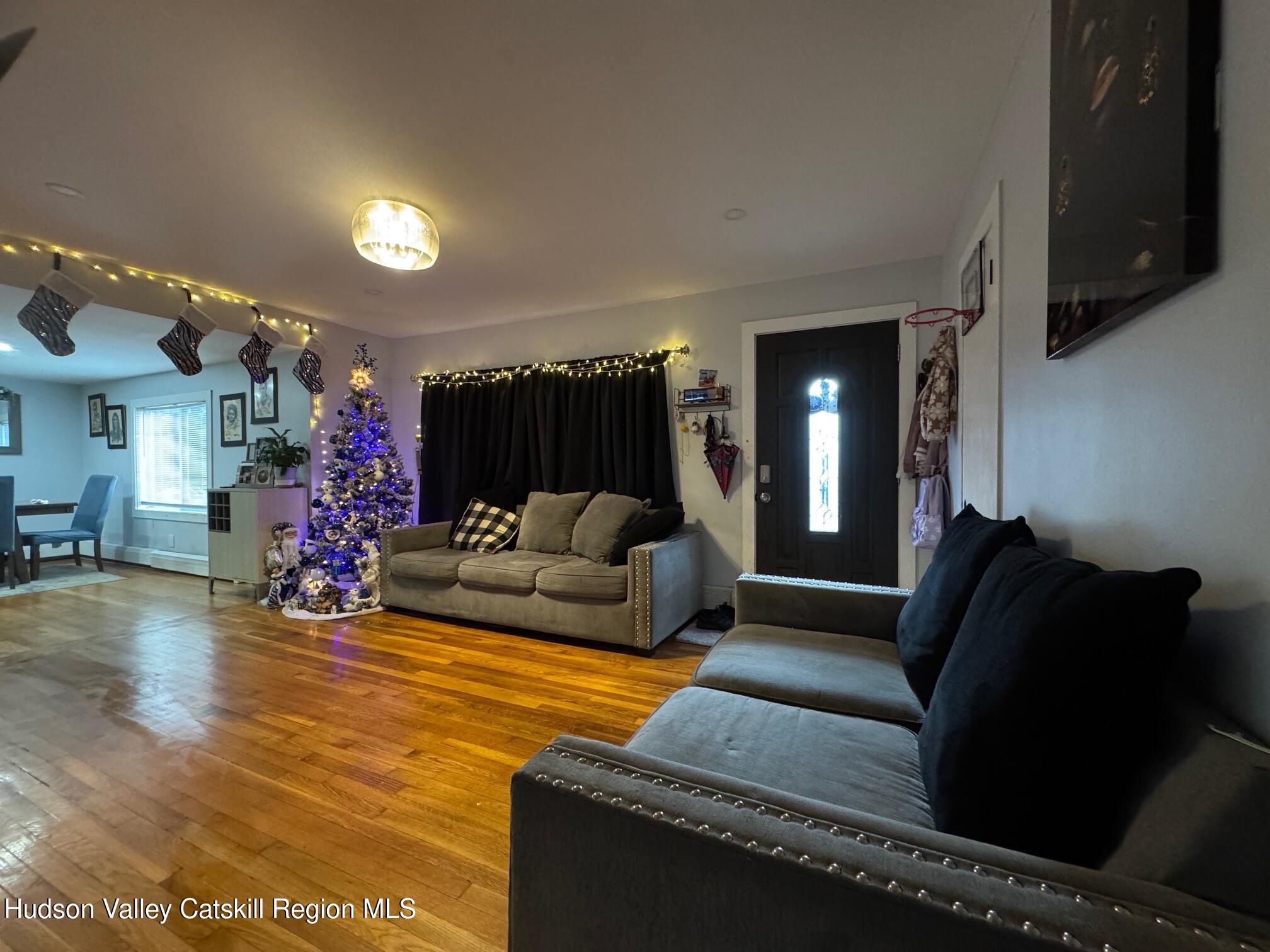 2 Spaulding Lane Saugerties, NY 12477 - Photo 9 of 24 a living room with furniture and a chandelier